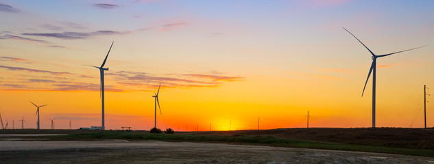 Wall Mural - wind generators of ecological power plant at sunset