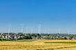 small village with a wind turbines on a horizon