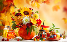 Concept Of Autumn Festive Decoration For Thanksgiving Day Or Halloween. Autumn Bouquet Of Beautiful Flowers And Berries In A Pumpkin, Different Fruits And Drinks On Wooden White Table.