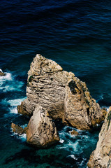 Sticker - Vertical high angle shot of big rock formations in the sea