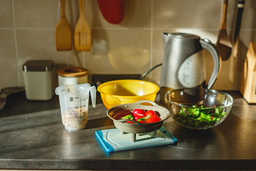 Sticker - Various coloured organic vegetables washed in colander in kitchen