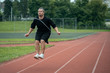 © goami - young athlete has workout and jumps on skipping rope outdoor