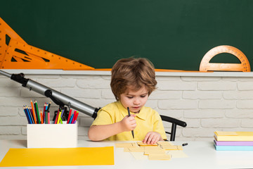 Fototapete - Portrait of Pupil in classroom. Elementary school and education. Individual tutoring.