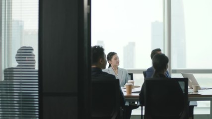 Wall Mural - young asian business woman getting applause after delivering a presentation in team meeting in conference room