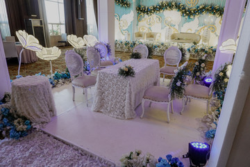 luxury wedding stage with chair and table with blue and white flower theme