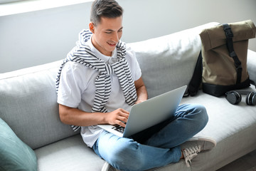 Poster - Man with laptop booking tickets online at home