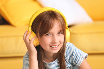 Canvas Print - Little girl listening to music at home