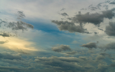 Wall Mural - blue sky and dark clouds. blue sky and gray clouds with golden light of sun. stormy sky. nature back