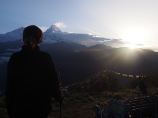 Wall Mural - A woman looking great nature with sunrise, A hill station 