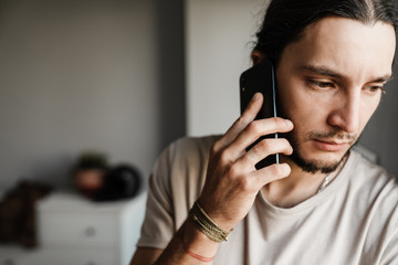 Close up of a concerned mman talking on mobile phone