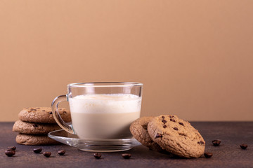 Sticker - Cappuccino coffee with chocolate cookies on a tawny background.