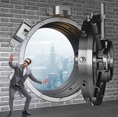 Blindfolded businessman in front ot vault door