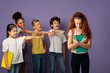 © Prostock-studio - Group of mean schoolchildren bullying their upset red-haired classmate over violet background