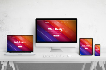 Fototapete - Responsive web site design on different devices. Web design studio desk with laptop, computer display, tablet and mobile phone