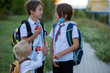 © Tomsickova - School children, boys wearing medical masks, going back to school after the summer vacation