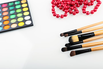 colorful cosmetic background with make up brushes and products