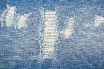 patch tear denim jeans textile texture surface for background or wallpaper with copy space. close up