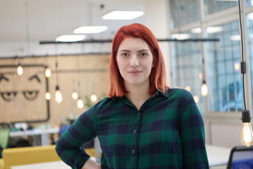 Poster - redhead woman at work  in creative modern coworking startup open space office