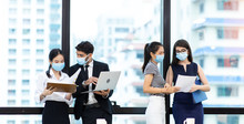 Young Businesswoman And Business Man Wearing Protective Face Mask While meeting For Making New Business Plans During COVID-19 Pandemic