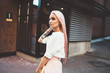 © BullRun - Thoughtful female youngster with colored pink hair standing at city urbanity and thinking, contemplative Caucasian hipster girl 20 years old pondering on information during day walk in soft focus