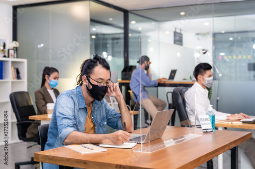 Fototapeta na drzwi i meble Social distance office with business team wear face mask as new normal life