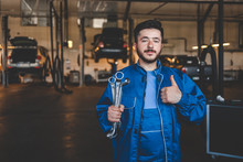 Car Mechanic With Wrench Shows Thumb Up