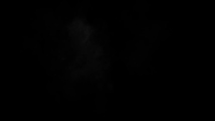 Dusty bullet hits on a wall with chunks of debris flying out . Powder explosion on black background. Impact dust particles. Dust explosion in front of black background, slow-motion close up. VFX