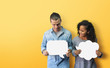 © eggeeggjiew - Happy Diversity couple holding white speech bubble on yellow background