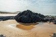 Photograph of a stunning black rock on Nature's Valley beach in the Western Cape, South Africa.