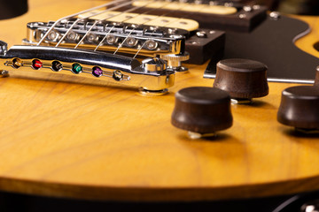 front part of the body of an electric guitar on black background