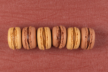 Poster - Six coffee and chocolated flavoured macaroons on vinyl background