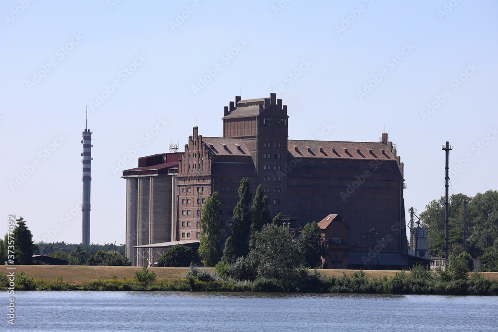 Obraz na płótnie an old granary by the river hung in Płock w salonie