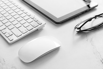 PC mouse, keyboard and tablet computer on table