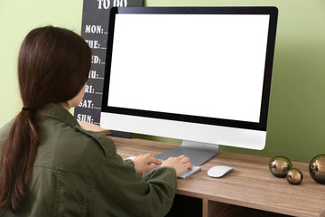 Young woman using computer at home