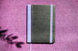 © GRAFStock - Notebook with violet flowers on a wooden abstract background.Book opens with a purse on a wooden background.