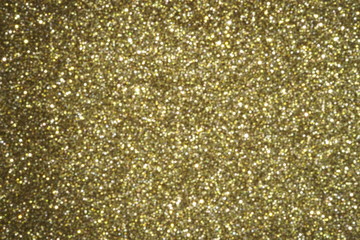 gold Sparkling Lights Festive background with texture. Abstract Christmas twinkled bright bokeh defocused and Falling stars. Winter Card or invitation	