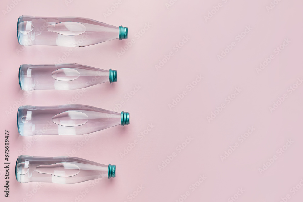 Bottles of clean water on color background