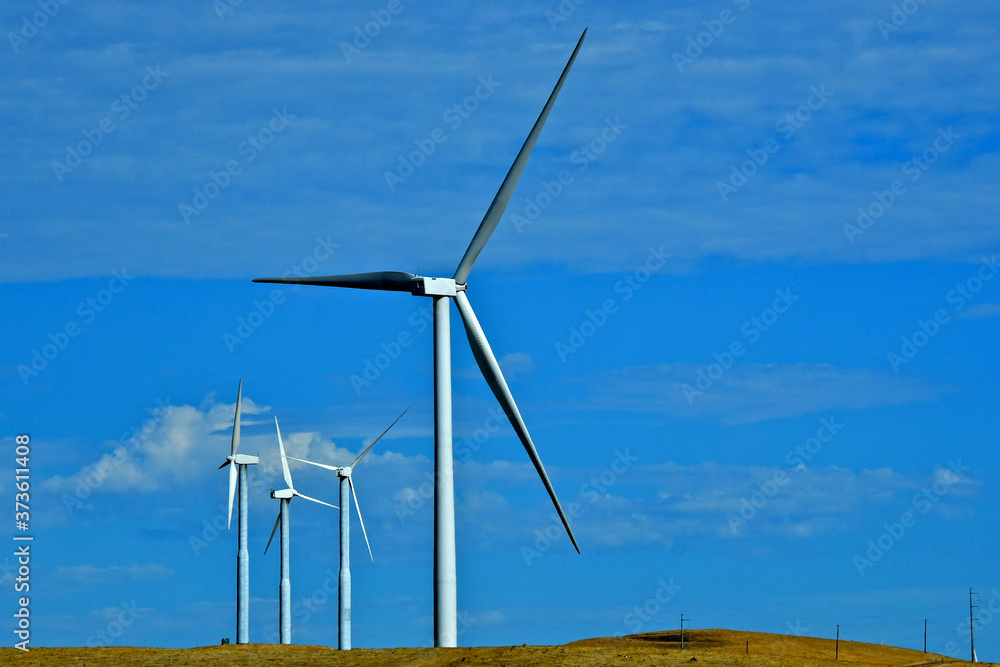 Wind turbines converts kinetic energy into electrical energy. The two