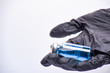 © Aleksander Savelev - A woman's hand in black gloves holds an ampoule. Vaccine. The ampoule with the medicine. Medication for injection.