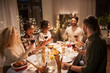© Syda Productions - holidays, celebration and people concept - happy friends having christmas dinner at home drinking non-alcoholic red wine