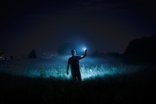 Person With Flashlight At Night