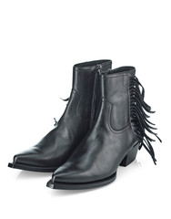 Black leather half-boots with a leather fringe on the top, a narrow toe and a sloping heel. Cowboy boots. Top view at an angle.