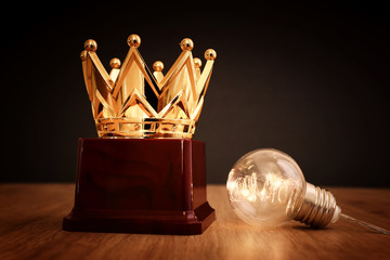 Wall Mural - image of golden crown award over wooden table.