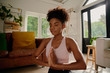 Portrait of young african woman with closed eyes practicing yoga with joint hands