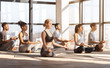 © Prostock-studio - Group Yoga Practice. Relaxed Multiracial People Meditating With Closed Eyes In Studio