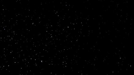 natural organic dust particles floating on black background. dynamic dust particles randomly float i