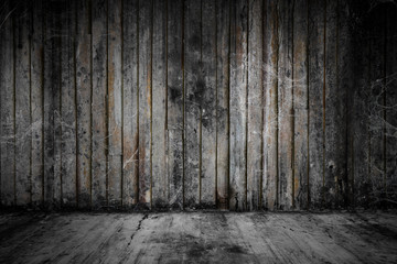 Old grunge wooden room and concrete floor covered with cobweb or spider web, concept of horror and scary