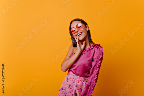 Photographie �lm woman in pink top with frill poses, showing joy
