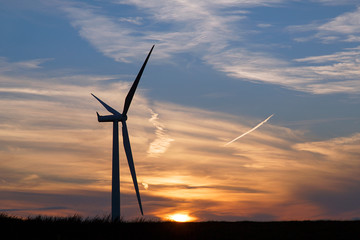 Wind turbine renewable alternative energy concept with a sunset background - UK