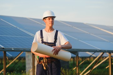 Worker installing solar panels outdoors